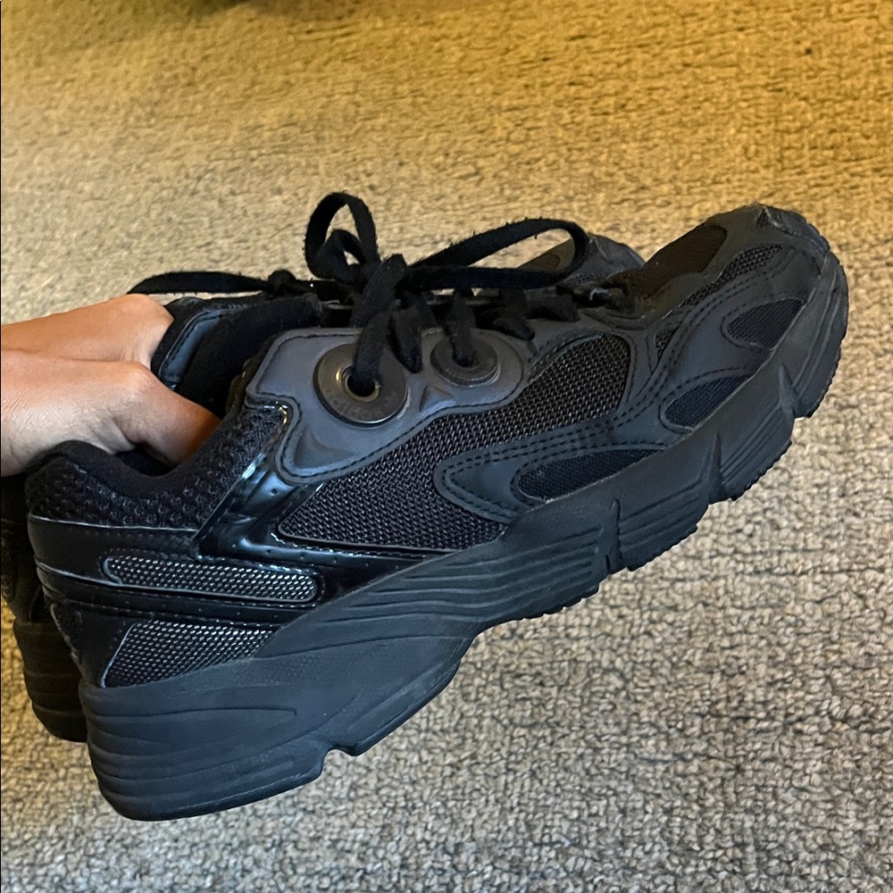 Woman’s black Adidas sneakers
